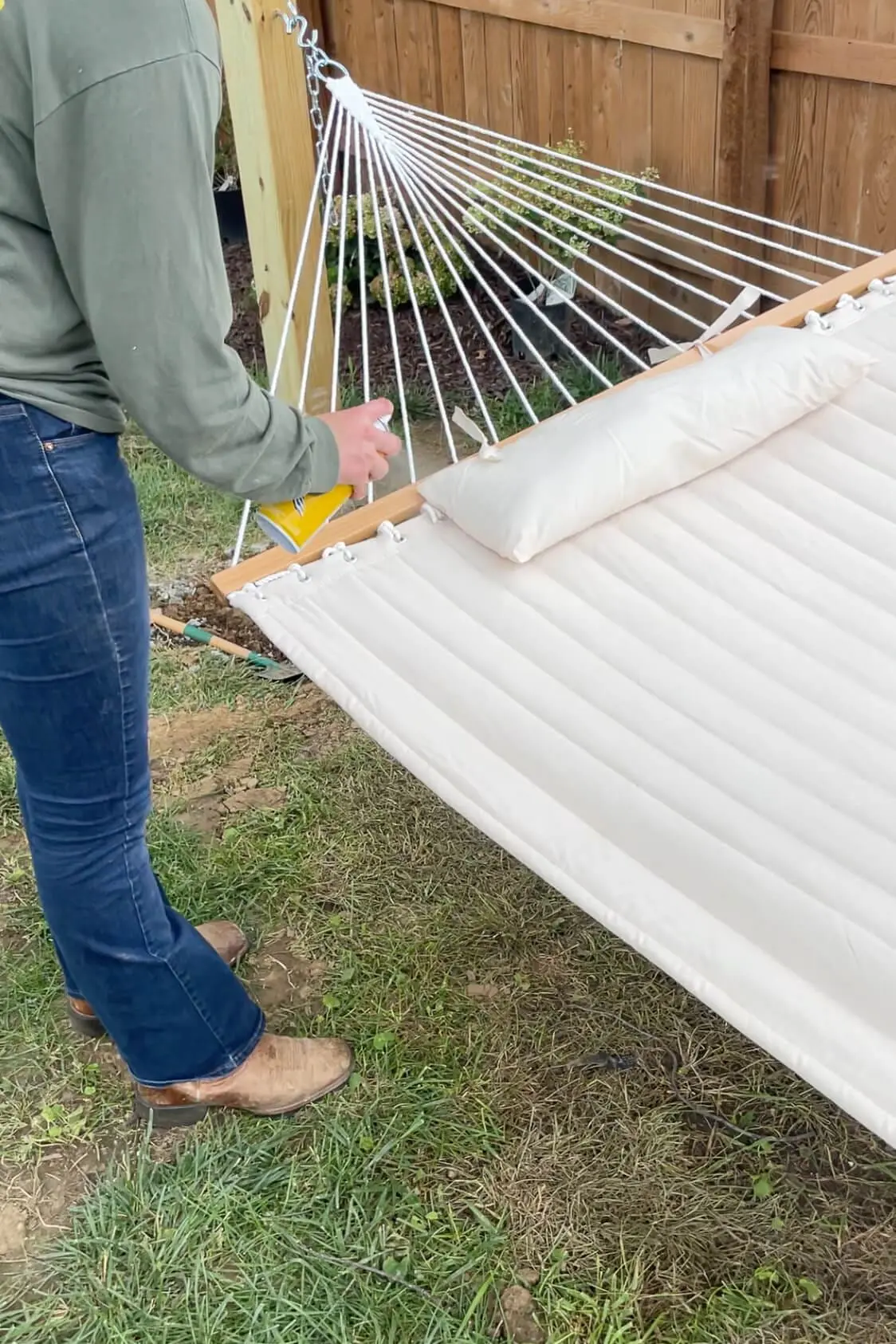Treating a backyard hammock with Scotchguard.